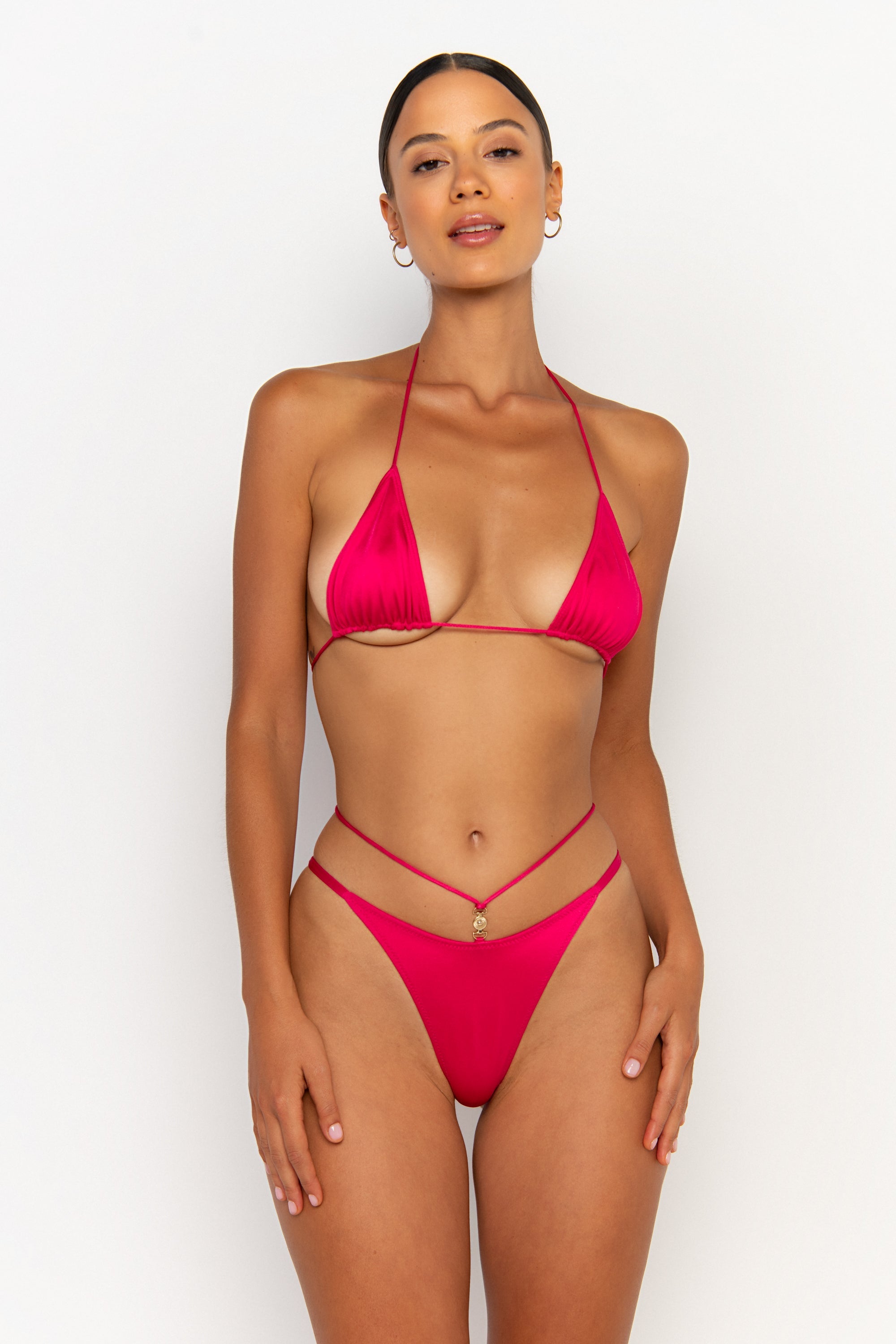 front view elegant woman wearing luxury swimsuit from sommer swim - kamilla magenta is a fuchsia bikini with brazilian bikini bottom