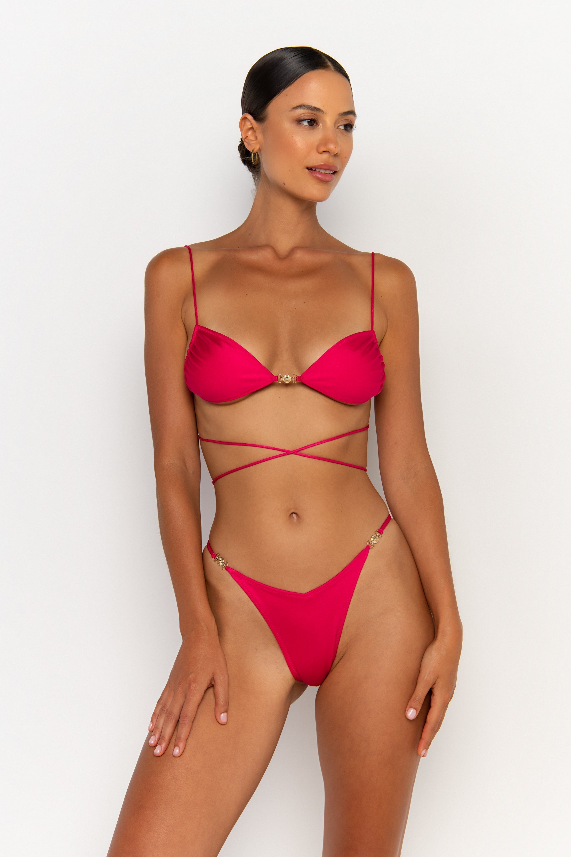 front alternative view elegant woman wearing luxury swimsuit from sommer swim - lia magenta is a fuchsia bikini with brazilian bikini bottom